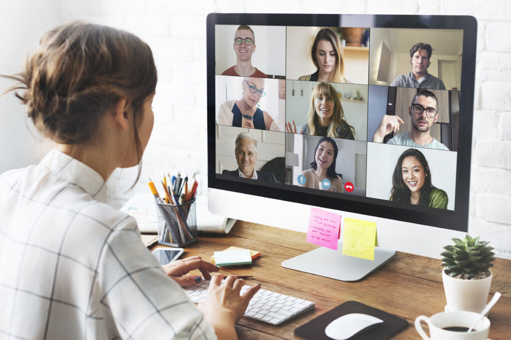Woman in a video conference call in her home office speaking to her team online
