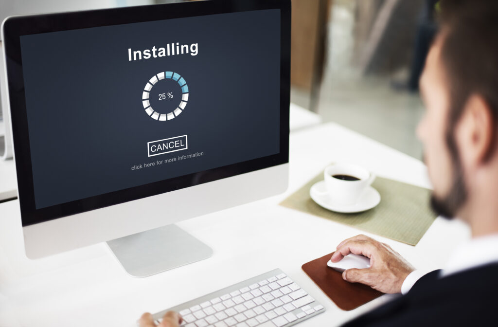 Man sitting at his desk Installing a new update